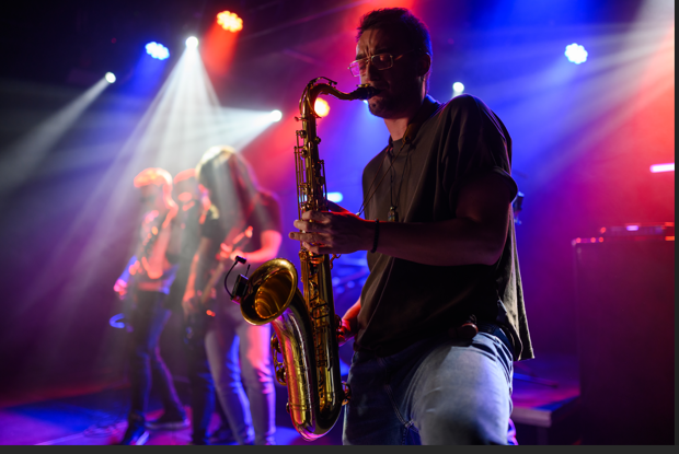 Saxophonist performing live on stage