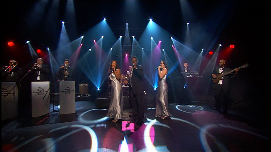 A group of people standing on top of a stage.