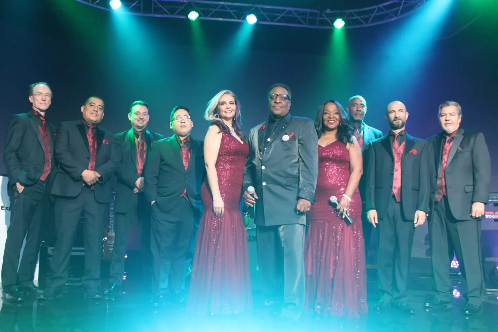 A group of people standing on top of a stage.